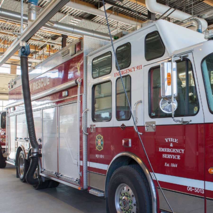 Firetruck with hose connected to the side of the fire truck