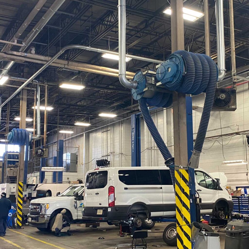 Vehicles in the Roanoke fleet garage with exhaust hoses visible