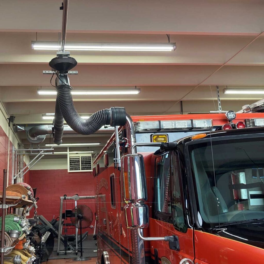 Orange ambulance with hose connected to top exhaust